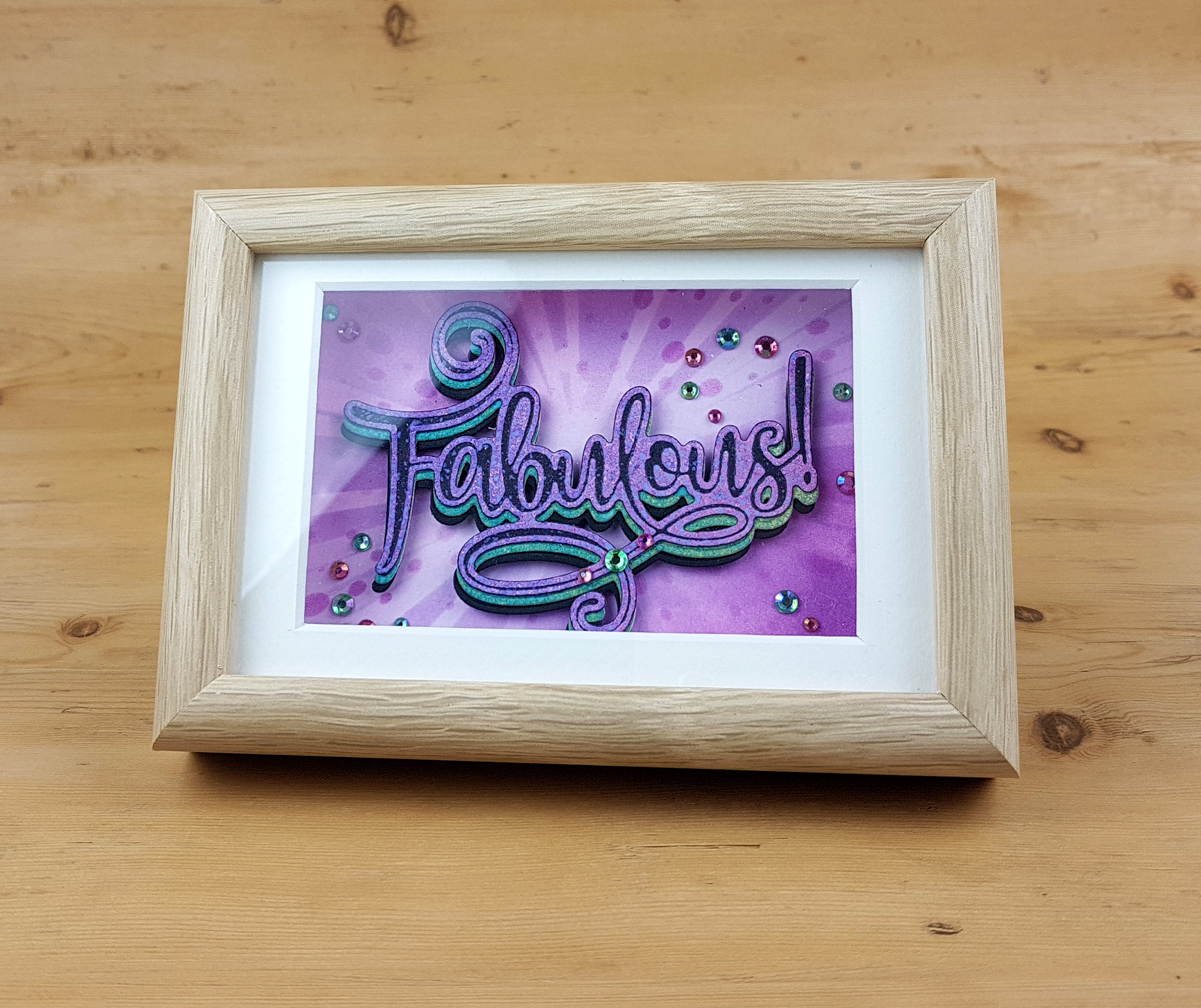 Image showing a framed die cut word. Design by John Bloodworth Gentleman Crafter featuring the Fabulous cut foil and emboss die from Couture Creations