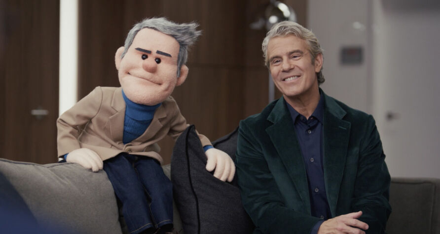 Likeness puppet of Andy Cohen, built for CNN — sitting next to the real thing.